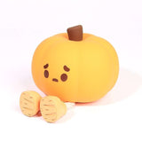 Small silicone pumpkin night lamp with cute facial expression and dangling legs, perfect for Halloween-themed ambient lighting and gifts.