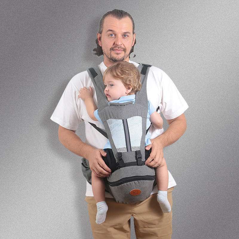 Gray ergonomic Baby Hip Seat Carrier with toddler, featuring wide shoulder straps and waist support. Ideal for baby transport and comfort.