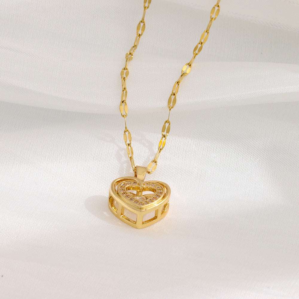 Gold Love Necklace with double-heart rhinestone pendant on a delicate chain, styled on white fabric. Chic Valentines Day jewelry gift.