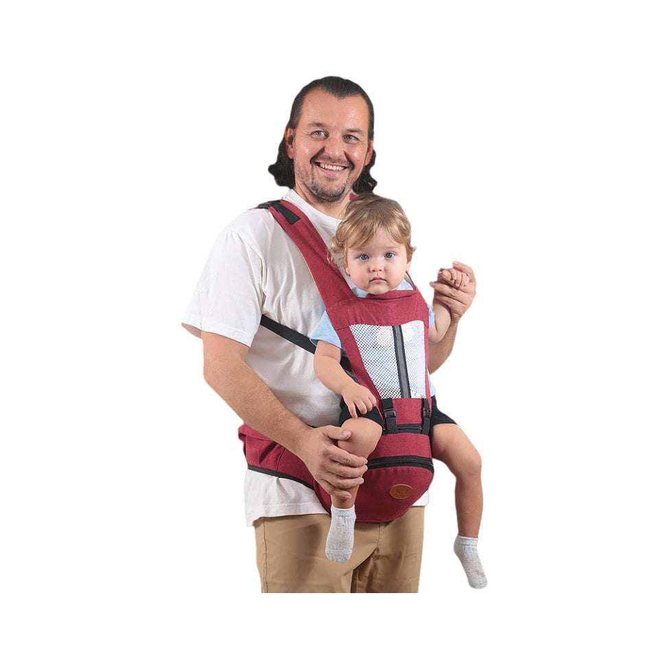 Red Baby Hip Seat Carrier with ergonomic seat and mesh front, securely holding toddler. Adjustable straps ensure comfort for both parent and child.