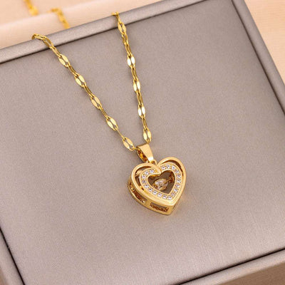 Love Necklace - Double-layer Steel Pendant in gold with rhinestone heart charm on twisted chain. Elegant fashion jewelry for women.