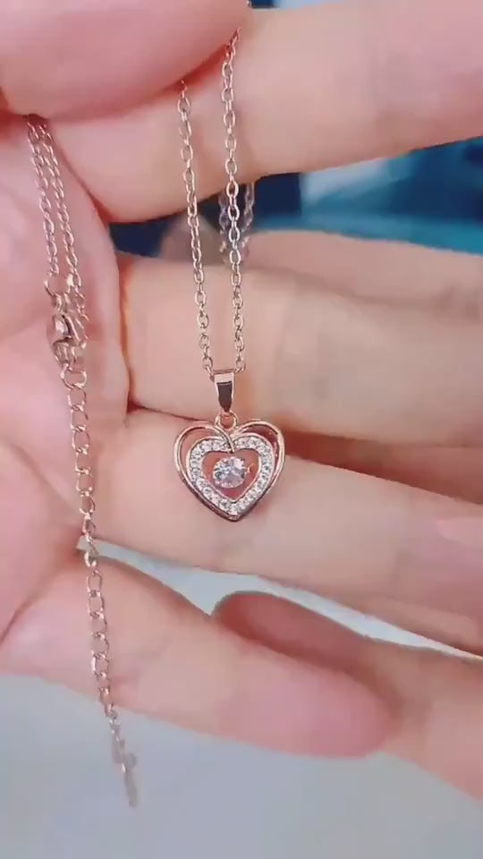 Rose gold Double-layer Love Necklace with rhinestone heart pendant held in hand. Romantic fashion jewelry for Valentines Day.